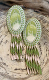 Swirling green oval beaded earrings with leather fringe