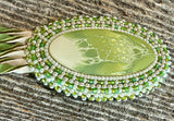 Swirling green oval beaded earrings with leather fringe