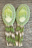 Swirling green oval beaded earrings with leather fringe